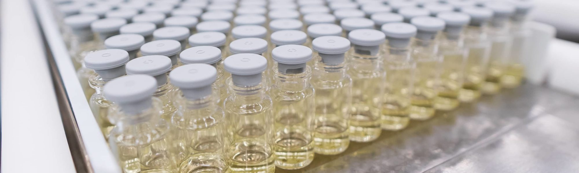 Aseptically filled vials prepared in trays for lyophilization