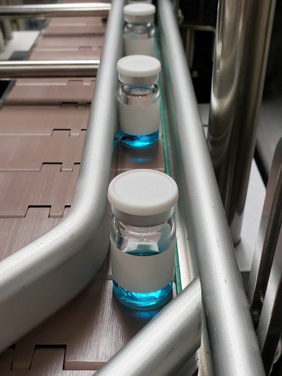 aseptic vial filling through line for labeling.