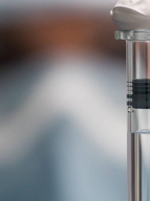 Operator inspecting syringe for release