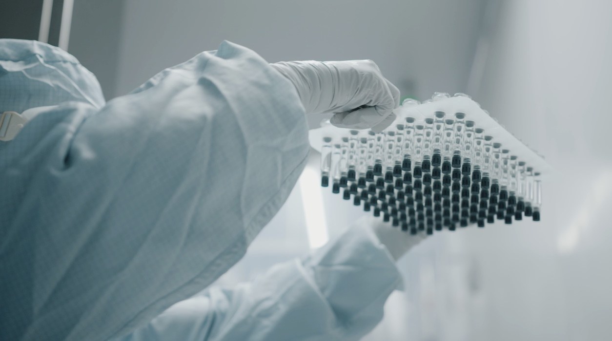 Scientist holding container of vials