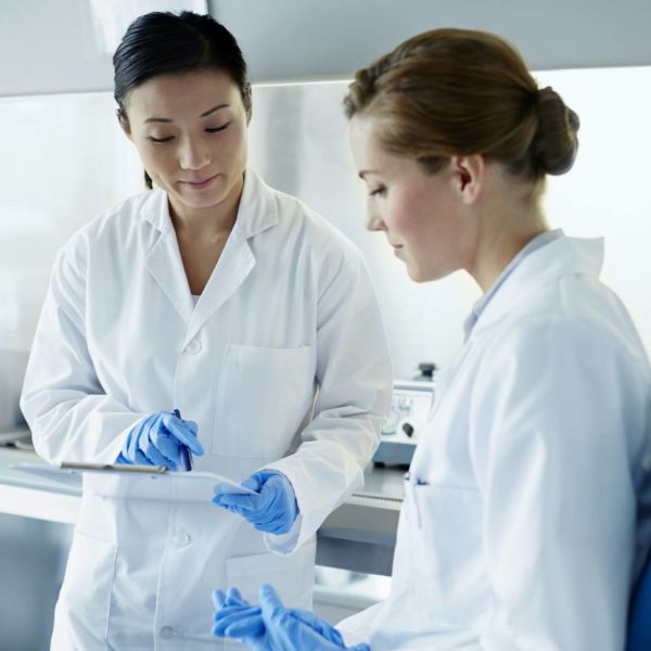 Two scientists running analytical tests
