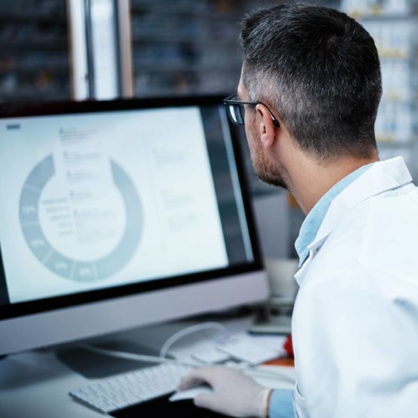 scientist at computer reviewing ich guidelines for stablility testing